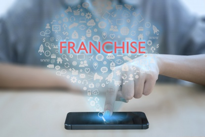 Woman using smart phone pressing button franchise icon. concept marketing branding retail and business work mission.